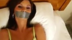 Tied Up And Tape Gagged On The Bed