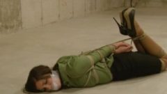 Woman With Green Blouse Is Hogtied On The Floor And Gagged