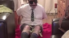 Dude Tied Up And Gagged Tightly In College Uniform With Strips Of Cloth